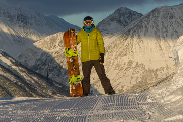 Dan and snowboard on the summit of Alyeska Resort. The mountains are absolutely enormous.